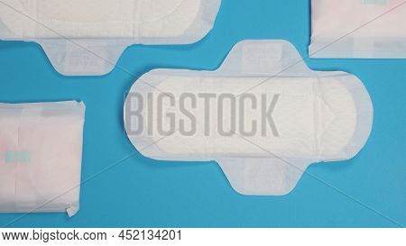 Woman Sanitary Napkins On Blue Background. Top View.