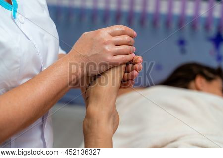 Facial Massage. A Woman Is Given A Massage In A Beauty Salon. Close-up.
