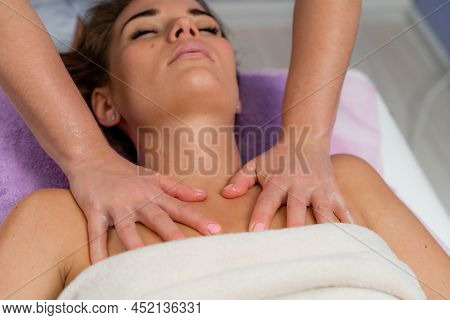 Facial Massage. A Woman Is Given A Massage In A Beauty Salon. Close-up.