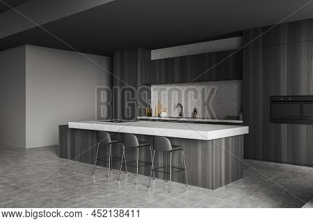 Corner View On Dark Kitchen Room Interior With Island With Barstools, Oven, Sink, Oil, Crockery, Con