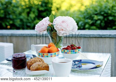 Breakfast Table With Bread, Fresh Fruits And Strawberries And Coffee Served On Balkony Terrace Or Ho