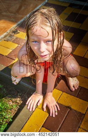Happy Funny Little Blone Girl With Wet Hair After Rain In A Summer Or Spring Day