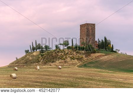 A Medieval Magnificent Torre Tarugi And A Rustic Old House On A Hill With Bales Of Hay And Trees Aro