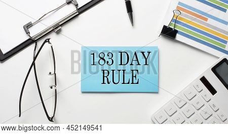 Stickers With Chart,calculator And Paper With Text 183 Day Rule On White Background