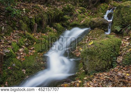 Beautiful Waterfall Landscape Image In Vibrant Autumn Woodland In Lake District