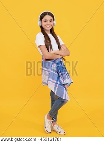 Happy Child In Casual Listening To Music In Headphones Yellow Background, Melomaniac