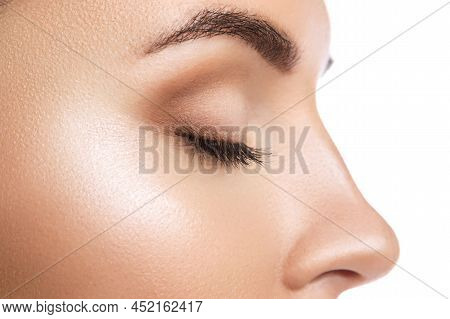 Closeup Of Closed Female Eye On White Background