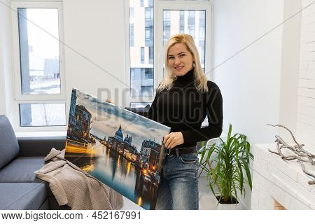 Photo Canvas Print. A Woman Holding A Photography With Gallery Wrap. Photo Printed On Glossy Synthet