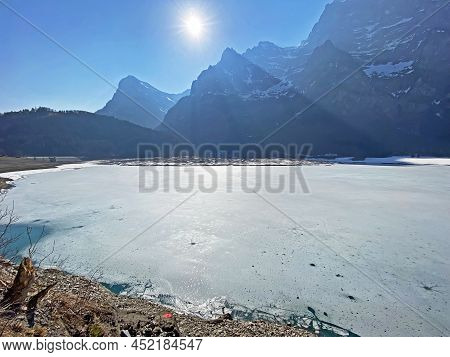 Frozen Klöntalersee Or Klontaler Lake During Early Spring In The Alpine Valley Klöntal (kloental Or 