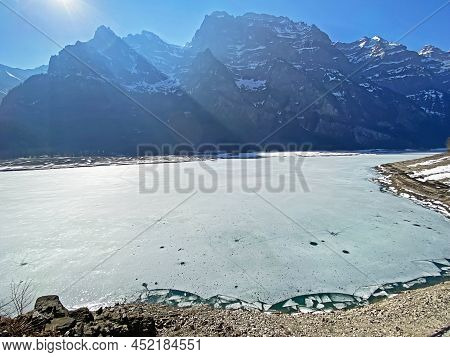Frozen Klöntalersee Or Klontaler Lake During Early Spring In The Alpine Valley Klöntal (kloental Or 