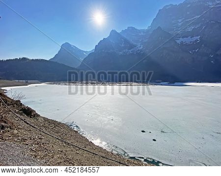 Frozen Klöntalersee Or Klontaler Lake During Early Spring In The Alpine Valley Klöntal (kloental Or 