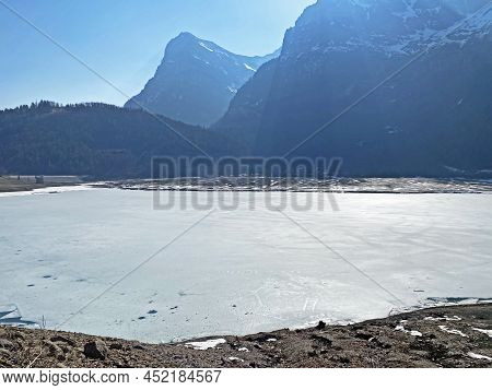 Frozen Klöntalersee Or Klontaler Lake During Early Spring In The Alpine Valley Klöntal (kloental Or 