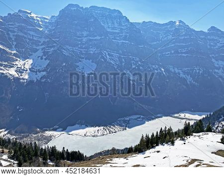 Frozen Klöntalersee Or Klontaler Lake During Early Spring In The Alpine Valley Klöntal (kloental Or 
