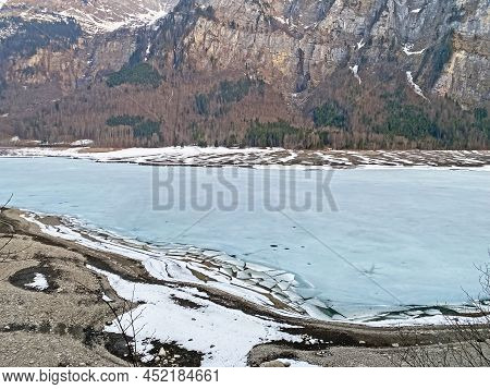 Frozen Klöntalersee Or Klontaler Lake During Early Spring In The Alpine Valley Klöntal (kloental Or 