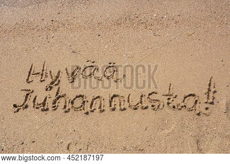 Finnish Words Hyvaa Juhannusta (happy Midsummer) Handwritten On A Sandy Beach