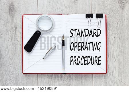 Sop - Standard Operating Procedure, Text On An Open Red Notebook On A Light Background