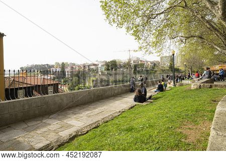 Porto, Portugal. March 2022.  People Relax Admiring The Panorama Of The City On The Virtudes Park