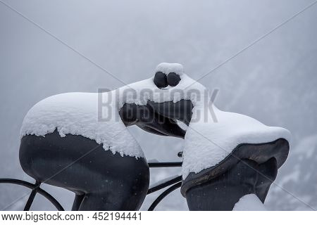 Escaldes Engordany, Andorra: 2022 April 2: Sculpture By Botero Cyclist And Woman Kiss. Whit Snowfall