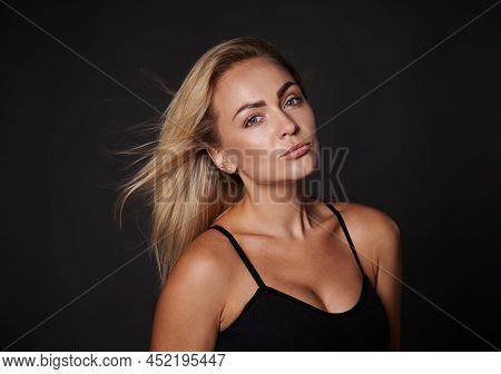 Beautiful Attractive Blonde Body Positive Caucasian Woman In Black Underwear Posing Against Dark Bac