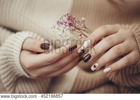 Close Up View Of Beautiful Female Hand With Fashion Manicure Nails Holding Hypsophila Flowers, White