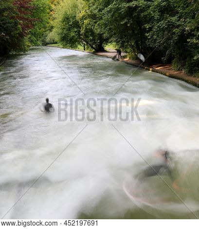River Of Munich In Germany Called Eisbach Where You Can Do The Sport Surfing And Young Surfer With T