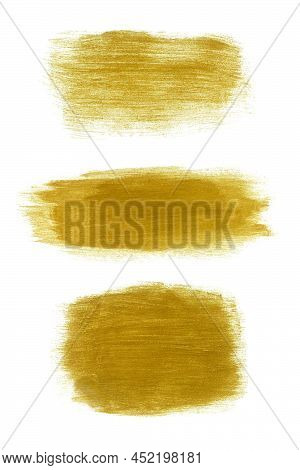 Set Of Golden Paint Brush Strokes Of Different Shapes. Gold Glittering Stain Isolated On White Backg