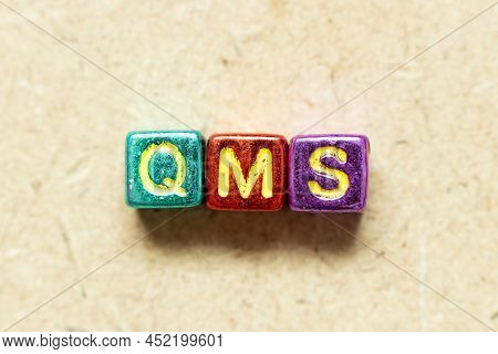 Metallic Color Alphabet Letter Block In Word Qms (abbreviation Of Quality Management System) On Wood