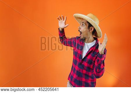 Black Man With Junina Party Outfit Scared Isolated On Orange Background.