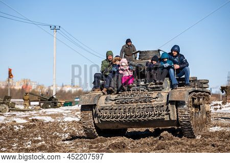 Saint-petersburg, Russia - March 27, 2022: Unidentified Children With Their Fathers Ride On A German