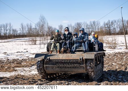 St. Petersburg, Russia - March 27, 2022: Unidentified Children With Their Parents Ride On A German S