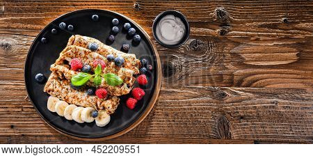 A Plate Of Pancakes With Cheese And Fruits