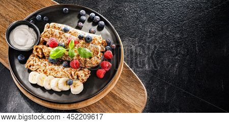 A Plate Of Pancakes With Cheese And Fruits