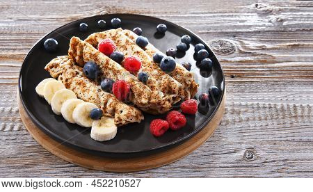 A Plate Of Pancakes With Cheese And Fruits