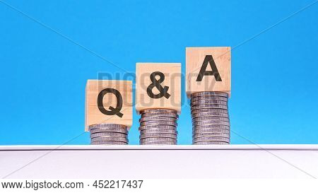 Q And A - Text On Wood Cube Block Stack With Coins