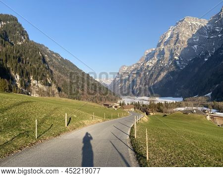 Paved Road By The Alpine Resevoir Lake Klöntalersee (kloentalersee Or Klontaler Lake) And In The Klö
