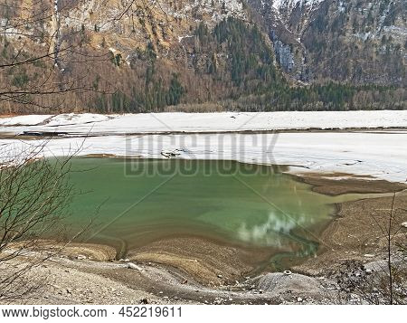 Thawing A Frozen Lake Klöntalersee Or Klontaler Lake During Early Spring In The Alpine Valley Klönta