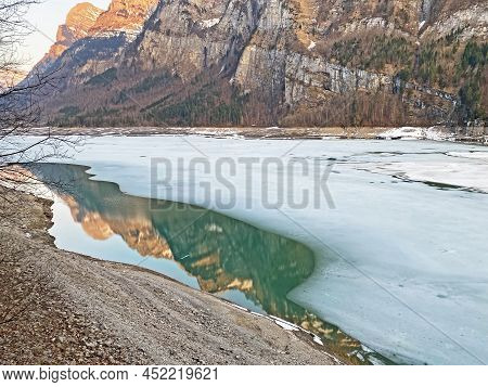 Thawing A Frozen Lake Klöntalersee Or Klontaler Lake During Early Spring In The Alpine Valley Klönta