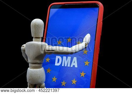 Wooden Mannequin Touching A Smartphone With The Text Dma And The Flag Of The European Union On The S