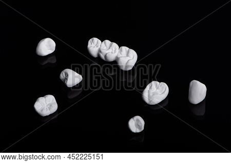 High Aesthetic Zirconia Dentures And Crowns On Colorful Background. Set Of Single Dentures And Denta
