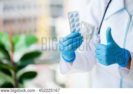 Closeup Of Female Doctor Holding Pill For Men Health