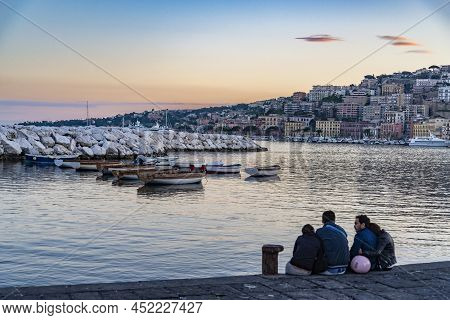 Naples, Italy - May 24, 2015: Two Couples View Over Fish Boats Embarked In The Bay Of Napoli On A Gl