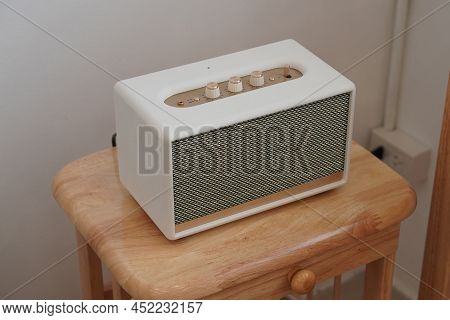 Closeup White And Gold Loudspeaker On Wooden Chair, Technology, Object,copy Space