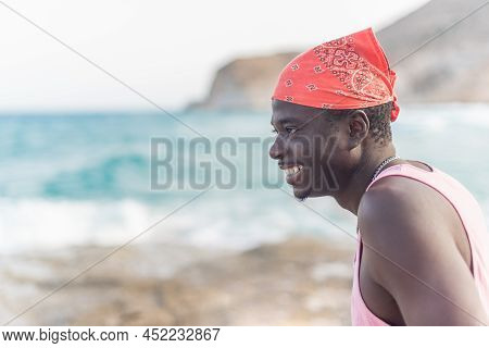 African Male Person Happily Enjoying The Summer Looking At Ocean