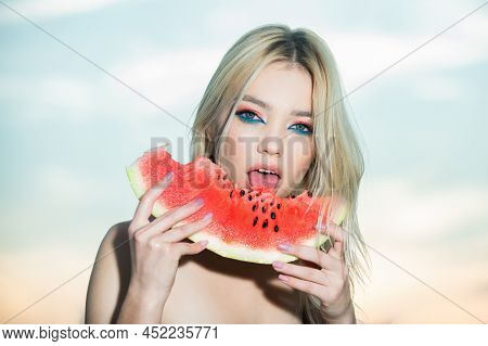 Portrait Of A Beautiful Young Blonde Woman With Blue Eyes Eating Watermelon.