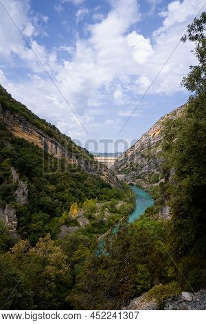 Deep Turquoise River At The Bottom Of A Vertical Canyon