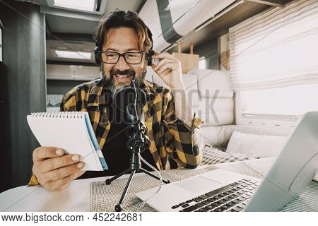 Portrait Of Handsome Adult Man Speaking To Microphone To Record Online Podcast. Modern Traveler Peop
