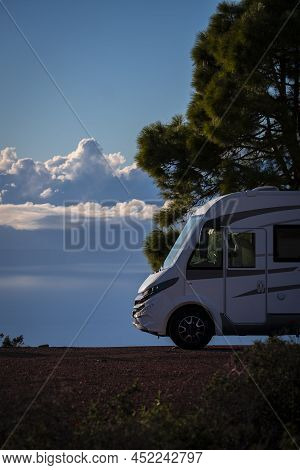 Modern Elegant Motorhome Cozy Home Parked Off Road With Blue Sky And Clouds In Background. Concept O