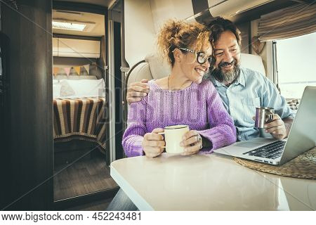 Camper Van Traveler Enjoy And Use Laptop Computer Together Inside Camper Van Rv. Modern People And R