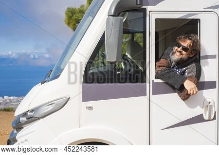Cheerful Happy Toutist Man Smile And Admire Outside The Driver Windows Of His Modern White Camper Ca