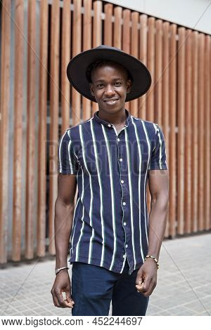 Portrait Of Hipster Young African Man With Trendy Casual Wear And Hat